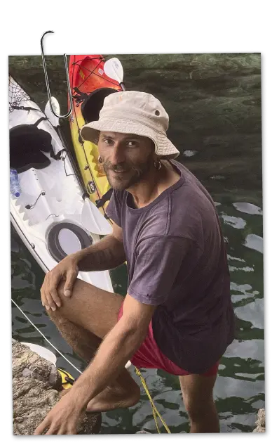 Guide Vasilii Bagrikov — with a kayak on the shore