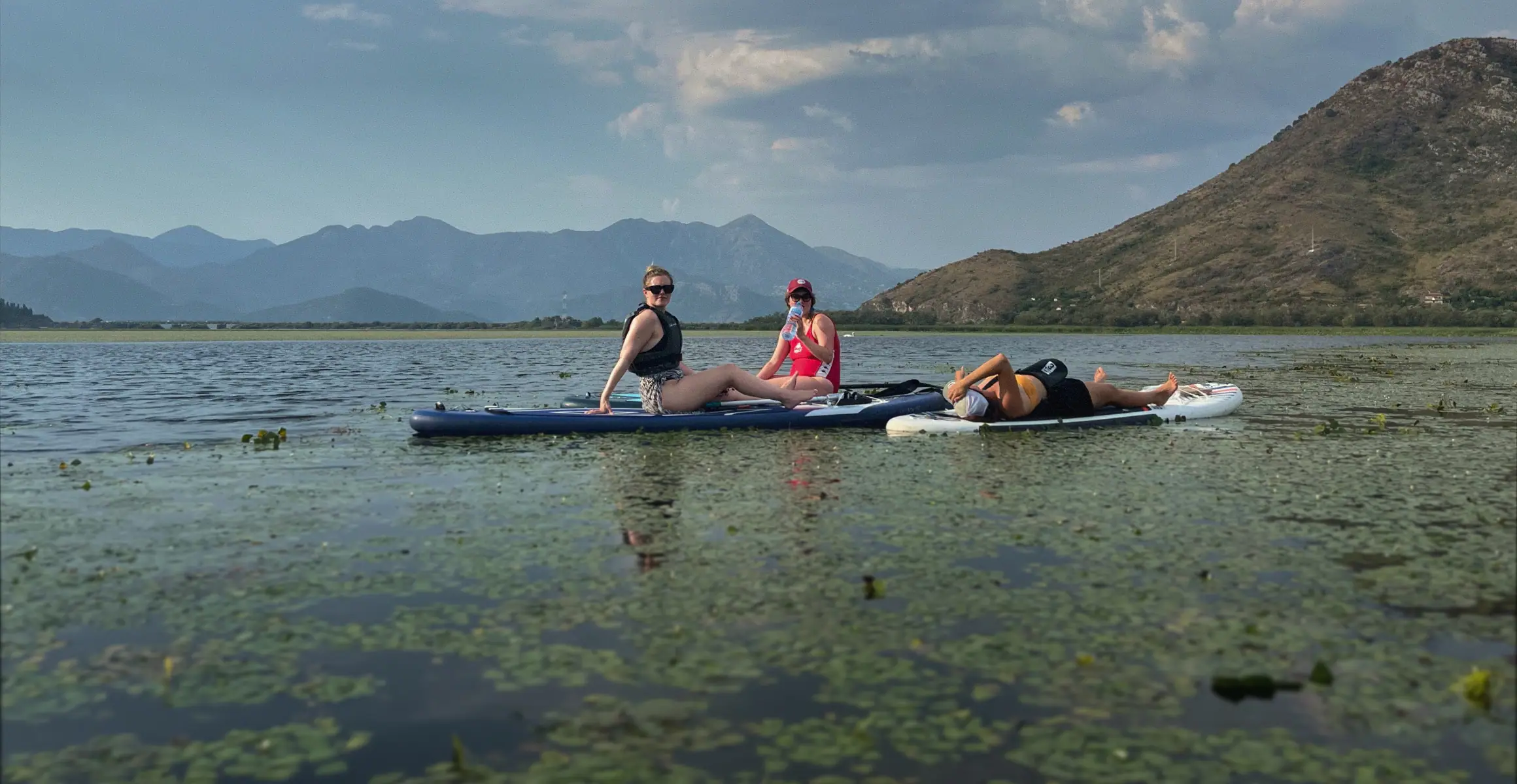 Paddlers exploring Skadar Lake on stand-up paddle boards