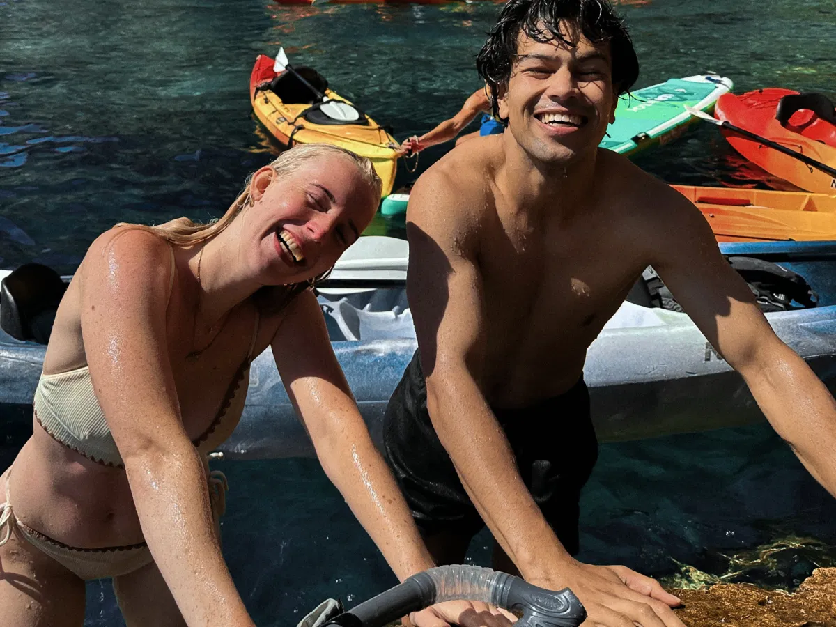 Two friends smiling and relaxing in the Blue Lagoon while snorkeling and enjoying the water