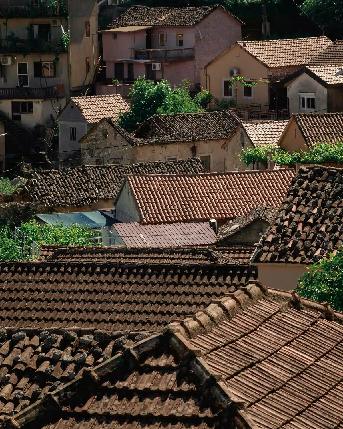 Terracotta rooftops and stone houses of a riverside Vranjina village near Skadar Lake