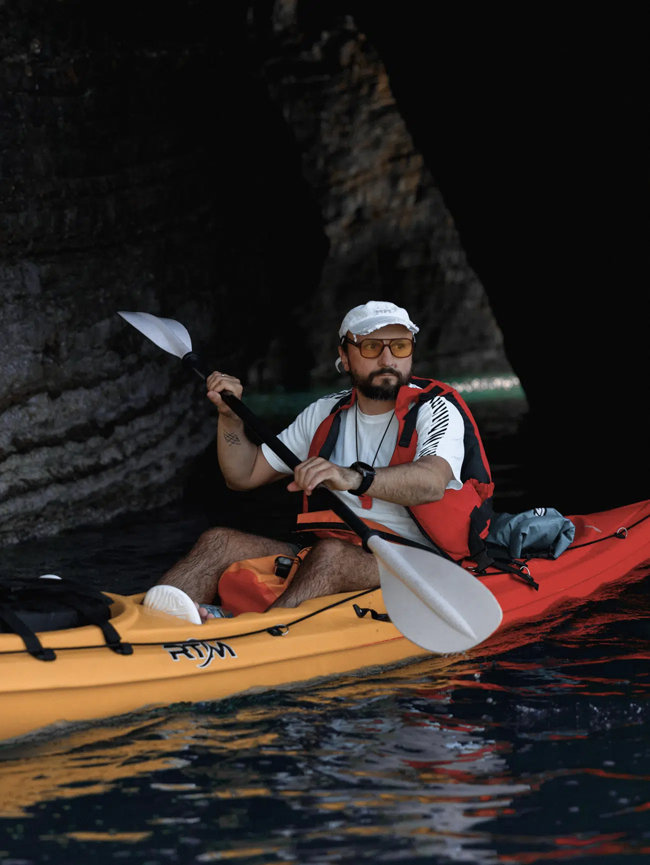 Guide Stepan Demchenko in an orange kayak preparing for a night tour