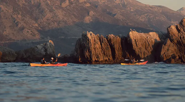 Kayakers paddling toward Petrovac Island