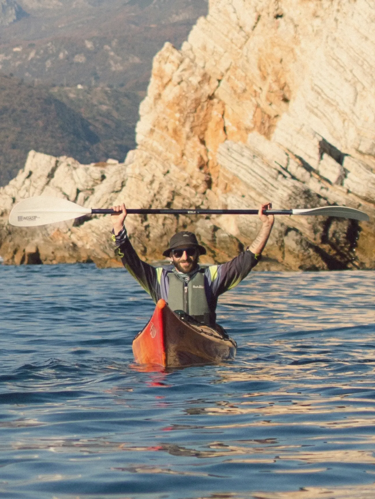 Guide Vasilii Bagrikov on the island trail holding a paddle and daypack