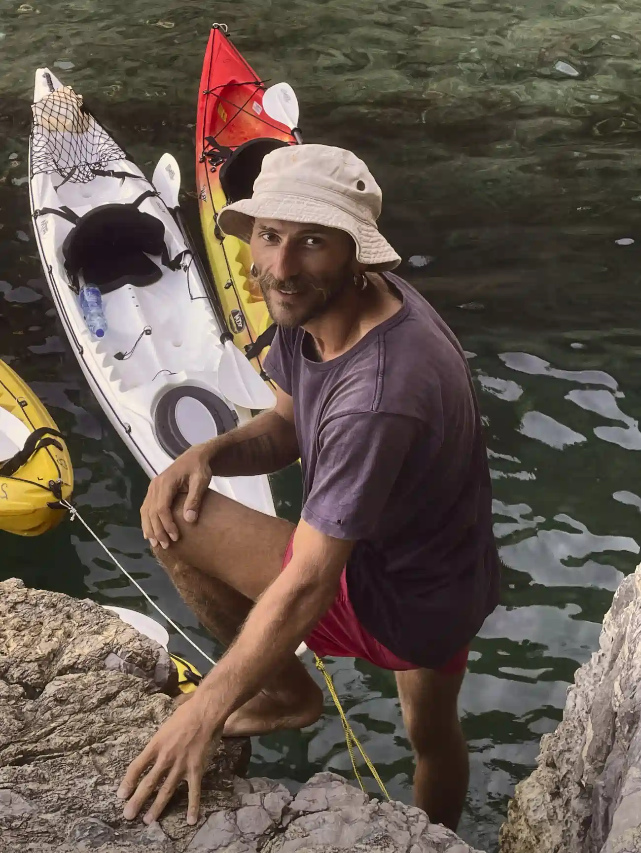 Guide  Vasilii Bagrikov on the island trail holding a paddle and daypack