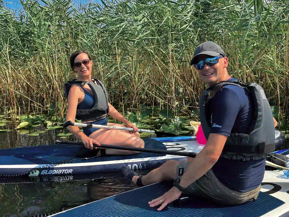 Vranjina Island loop tour: guests relaxing on SUP boards near the reeds on Skadar Lake