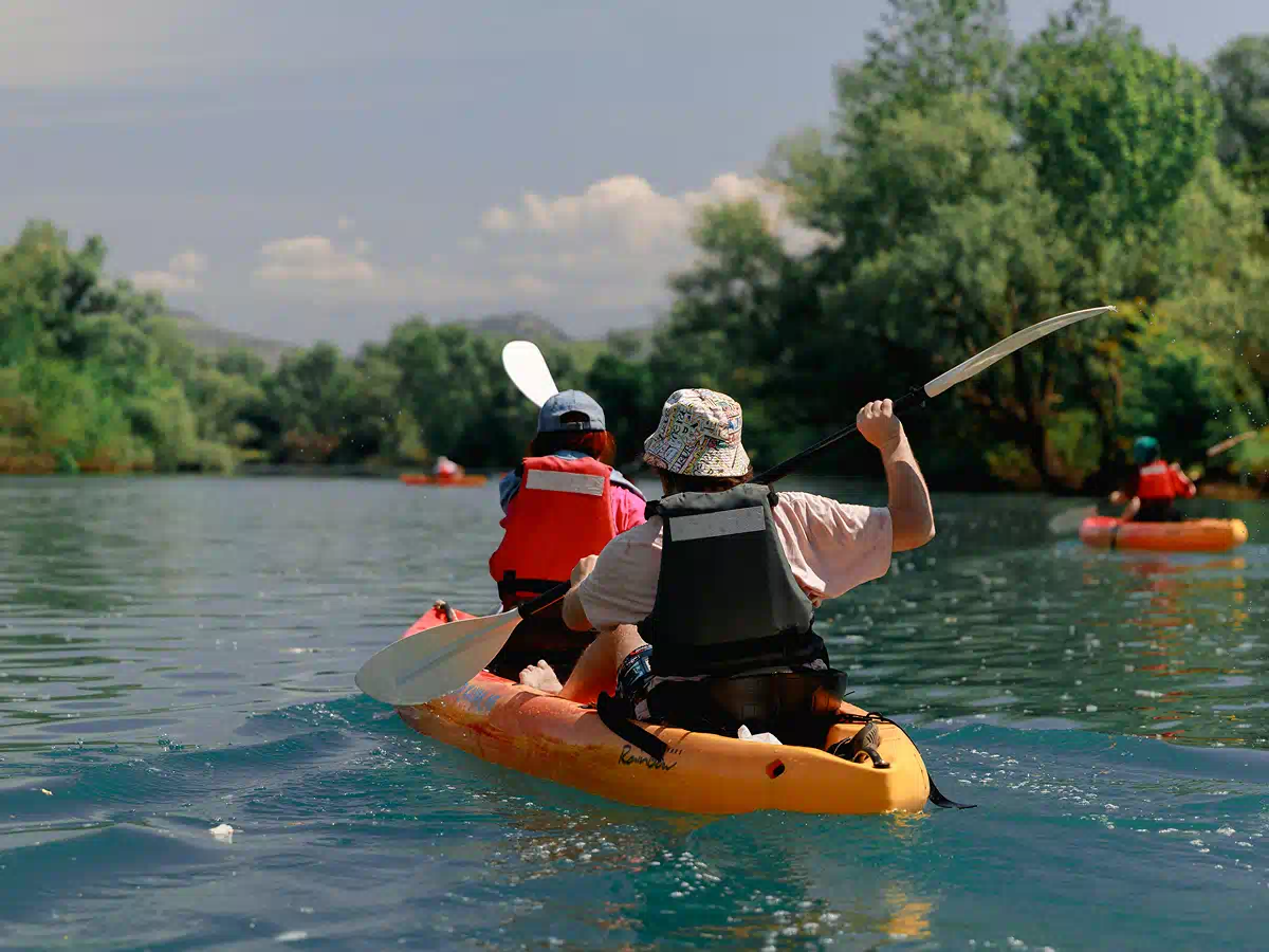 Two paddlers gliding on calm water as the river opens into Skadar Lake