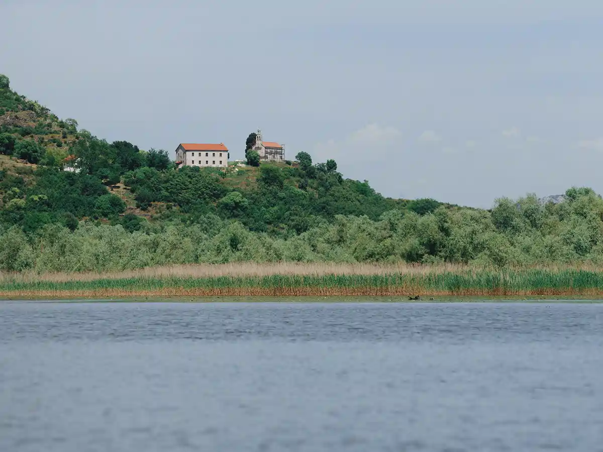 View of Vranjina Monastery on the hill above the river, Skadar Lake, Montenegro