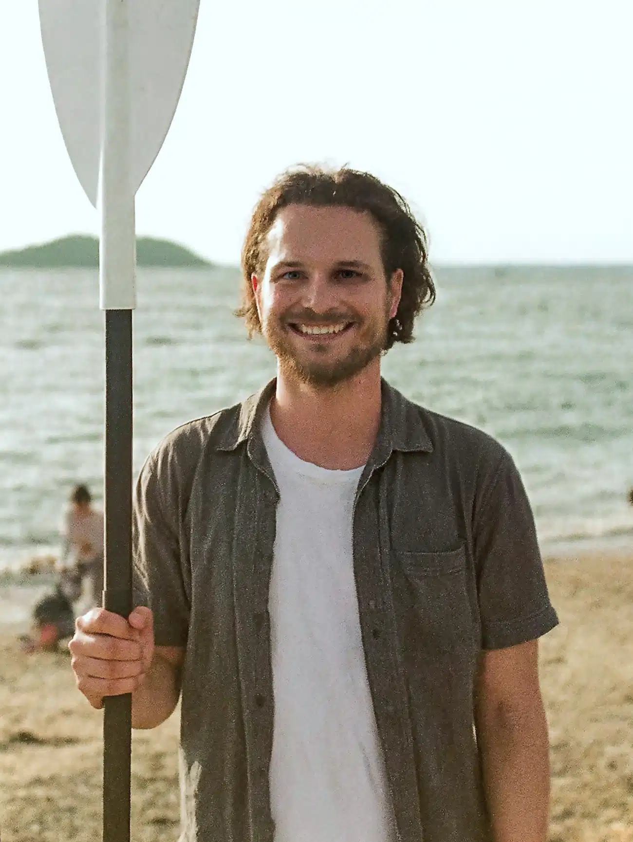 Kayak guide holding a paddle on the shore of Skadar Lake